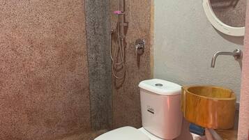 Deluxe Studio | Bathroom | Shower, slippers, towels, soap
