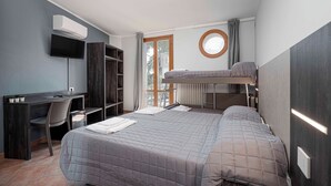 A compact bedroom with a bunk bed, a desk with a chair, a TV, and a window with curtains. - Urban Hotel (Cesena)