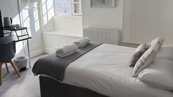 Desk, laptop workspace, blackout drapes, iron/ironing board