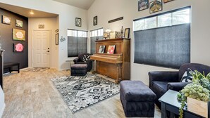 A spacious living area with a piano, comfortable seating, and artwork on the walls. - Labor Day Weekend Special: Flexible Check-in/out! (Phoenix)