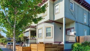 A two-story house with a front porch, a garage, and a wooden fence. - Pet-friendly Condo < 2 Mi to Alameda Beach! (Alameda)