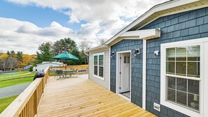 A wooden deck with a bench and umbrella, a door, and a window. - 8 Mi to Jiminy Peak Resort: Mtn-view Home w/ Deck (Stephentown)
