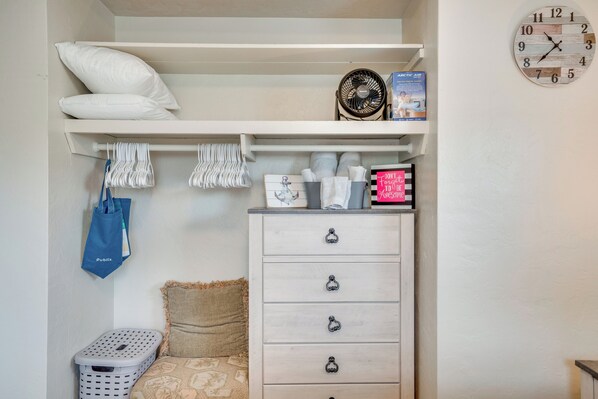 A bedroom with a bunk bed, a dresser, a clock, and a laundry basket. - Relax in Hot Tub, Walk to Springs: North Port Home (North Port)