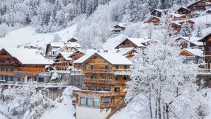 A snow-covered mountain resort with wooden buildings and a ski lift. - More Mountain - Chalet La Godille. Luxury Chalet with large Terrace and Outdoor Jacuzzi split over 3 levels next to the Super Morzine Telecabine. (Morzine)