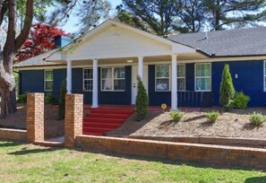 A two-story house with a front porch, red steps, and a brick column. - Bright, Spacious 2Bd 2.5Bt Townhome Interior (College Park)