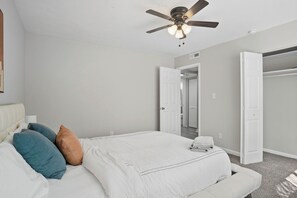 A bedroom with a bed, a ceiling fan, and a closet. - Wyndham Hills Retreat | Stylish & Serene Stay (Forest Park)