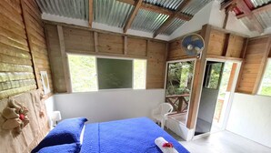 A room with a bed, a chair, and a fan. - Riverfront Home Perfect for Groups in the Middle of the Mountains (Vallejito Abajo)