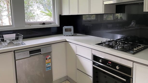 A kitchen with white cabinets, a dishwasher, a toaster, a stove, and an oven. - Shared house in Marsfield-Bright and Sunny/Bus/Mac Uni/Mac Centre (Marsfield)
