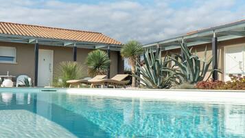 Seasonal outdoor pool, open 8:00 AM to 8:00 PM, pool umbrellas