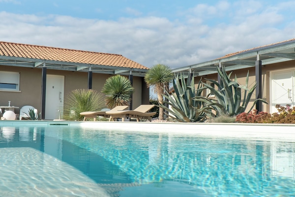 Seasonal outdoor pool, open 8:00 AM to 8:00 PM, pool umbrellas
