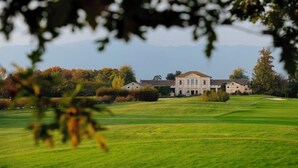 A large, historic building with a symmetrical facade, surrounded by a well-maintained lawn and trees with autumn foliage. - Magrine Castelfranco Veneto  (Castelfranco Veneto)
