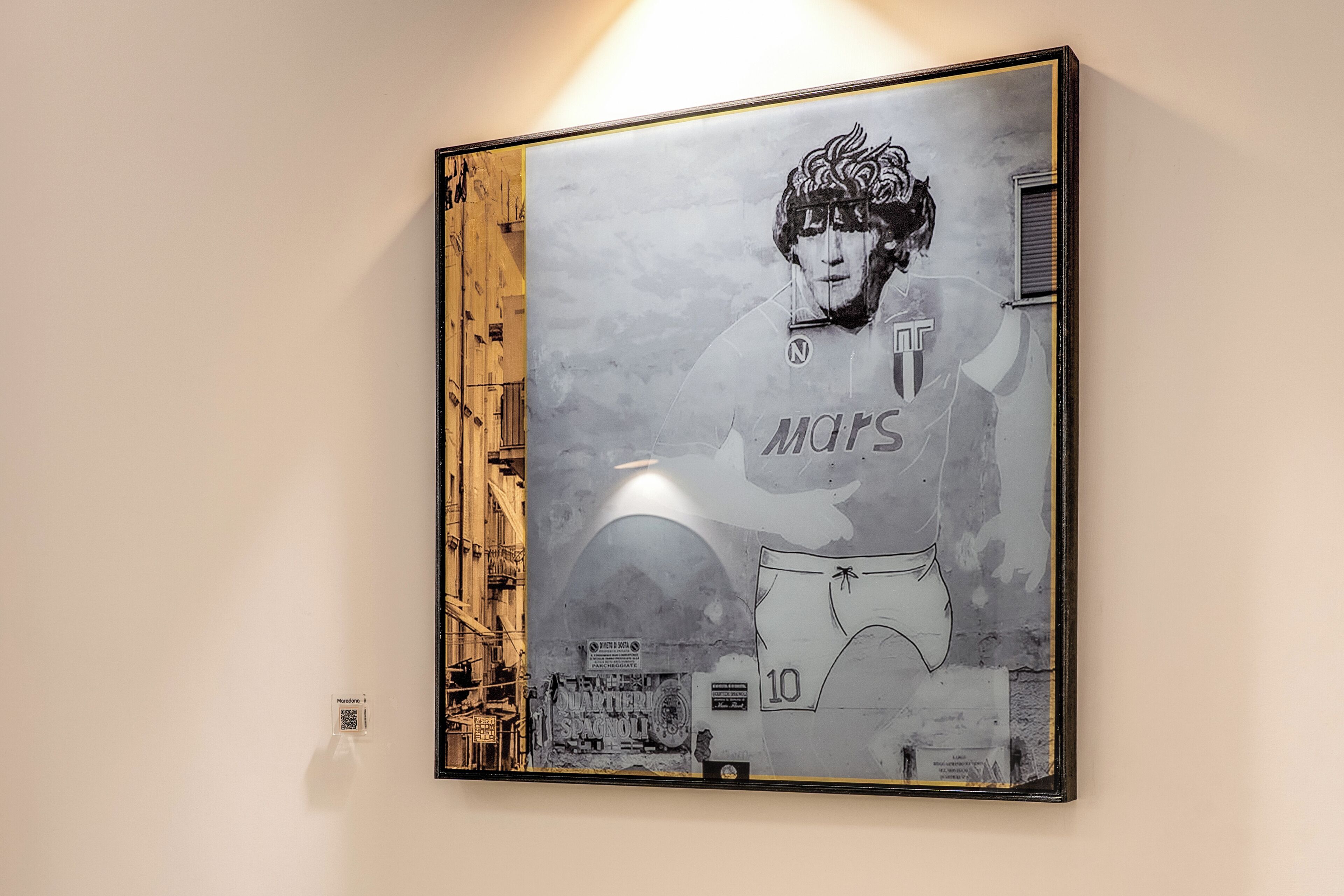 A framed artwork on a wall.