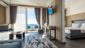 A modern hotel room with a bed, sofa, and a dining area with a table and chairs. - Hotel Continental Ulcinj (Ulcinj)