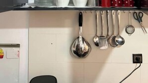A kitchen with open cabinets, a sink, and various utensils hanging on the wall. - Modern apartment in the heart of Marrakech, 9 min from airport -with Wi-Fi & A/C (Marrakech)