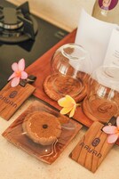 A wooden tray with a glass dome and a jar, a wooden block with a flower, and a glass container with a flower.