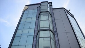 A modern building with a glass facade and a geometric design. - Ananya Hotel  (Digha)