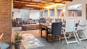 A cozy living area with a sofa, chairs, a coffee table, and a colorful rug. - 5 Star Holiday Home in Dronningmolle (Dronningmolle)