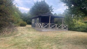 A small cabin with a wooden deck and a covered porch. - 4 Star Holiday Home in Nykobing Sj (Nykobing Sjaelland)