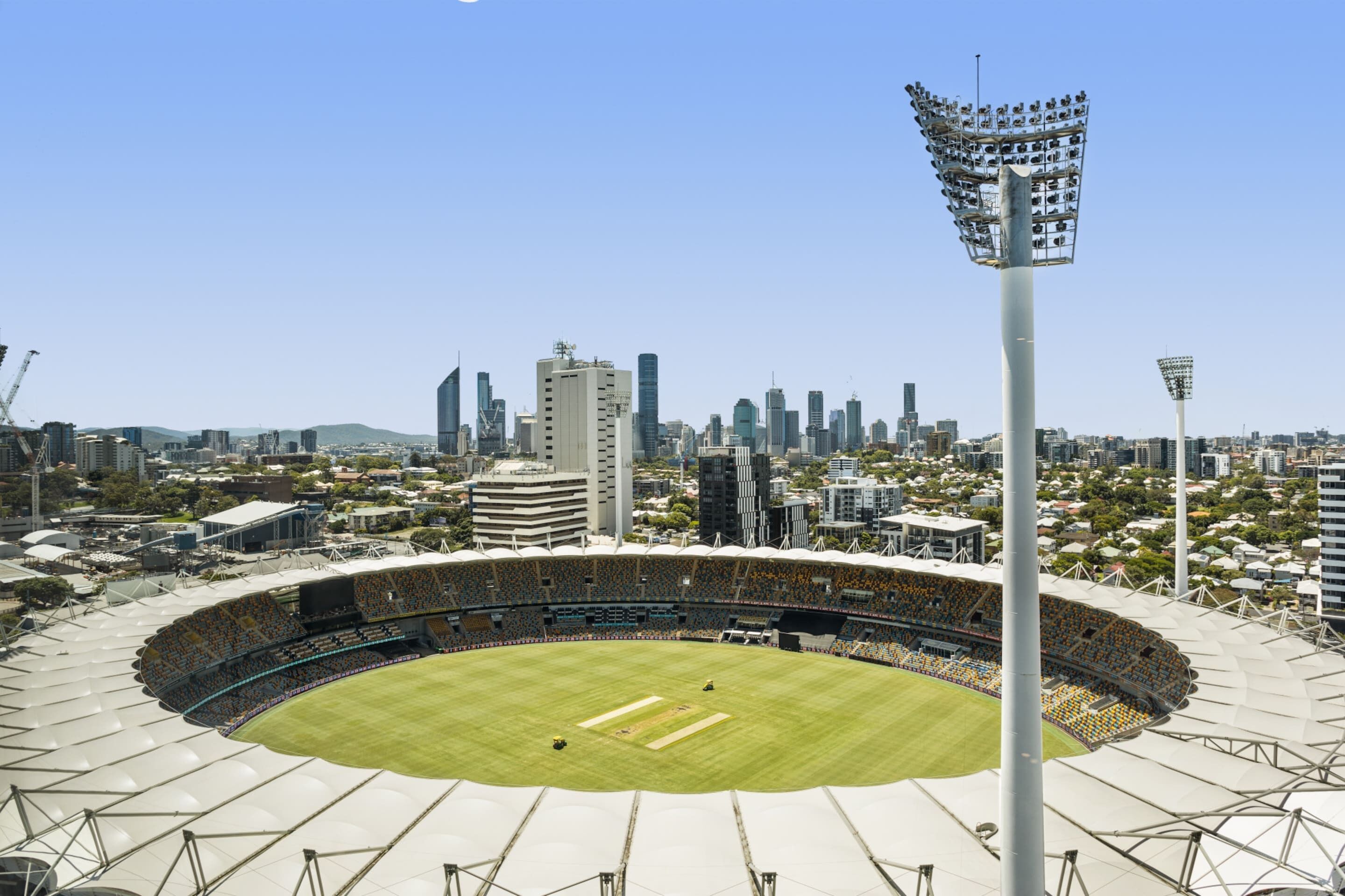 A stadium with a large seating area and a central field, surrounded by high-rise buildings.