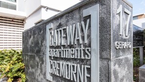 A stone sign with "GATEWAY Apartments CREMORNE" and the number "17" on it. - Professional Living Minutes From the City (Sydney)