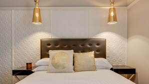 A neatly made bed with a tufted headboard, two bedside tables, and two wall-mounted lamps. - Family Retreat In Top Blue Mountains Location (Katoomba)