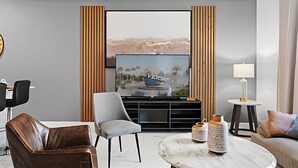 A modern living room with a flat-screen TV, a sofa, a coffee table, and a lamp. - Disney 4BR w/ Pool + Themed Rooms in Storey Lake (Kissimmee)