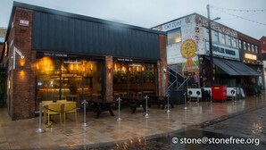 A restaurant with outdoor seating, a brick facade, and a mural on the adjacent building. - 2 Bedroom Marina Suite-203 (Kingston upon Hull)