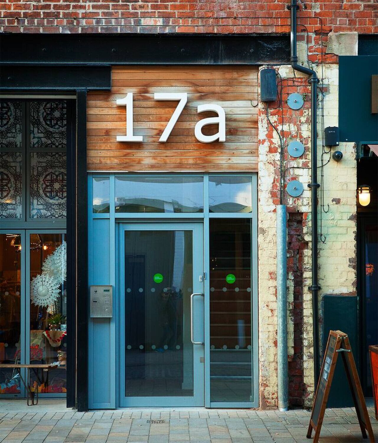 A storefront with a wooden facade and the number '17a' above the entrance.