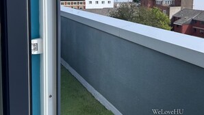 A view from a balcony with a clear sky, a building with the number 47, and a body of water in the background. - We Love HU -Sky Marina Suite (Kingston upon Hull)