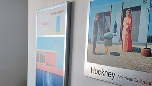 Dos obras de arte enmarcadas en una pared, una titulada 'Hockney' y la otra 'roger splash'.
