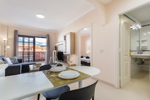 A modern living room with a dining area, a balcony with a view, and a separate bathroom. - Vacation Home 'Casa Marley – Balcòn Del Mar' with Shared Pool, Balcony and Wi-Fi (costa del Silencio)