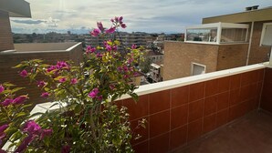 A rooftop with a view of a cityscape, a balcony with a plant, and a clear sky. - 'Between Sky and Sea by Vale' Apartment with Balcony and Air Conditioning (Fano)