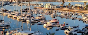 Ein Yachthafen mit zahlreichen Booten, ein kleines Gebäude und freie Weitsicht auf das Wasser.