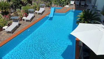Seasonal outdoor pool, open 9:00 AM to 7:00 PM, pool loungers