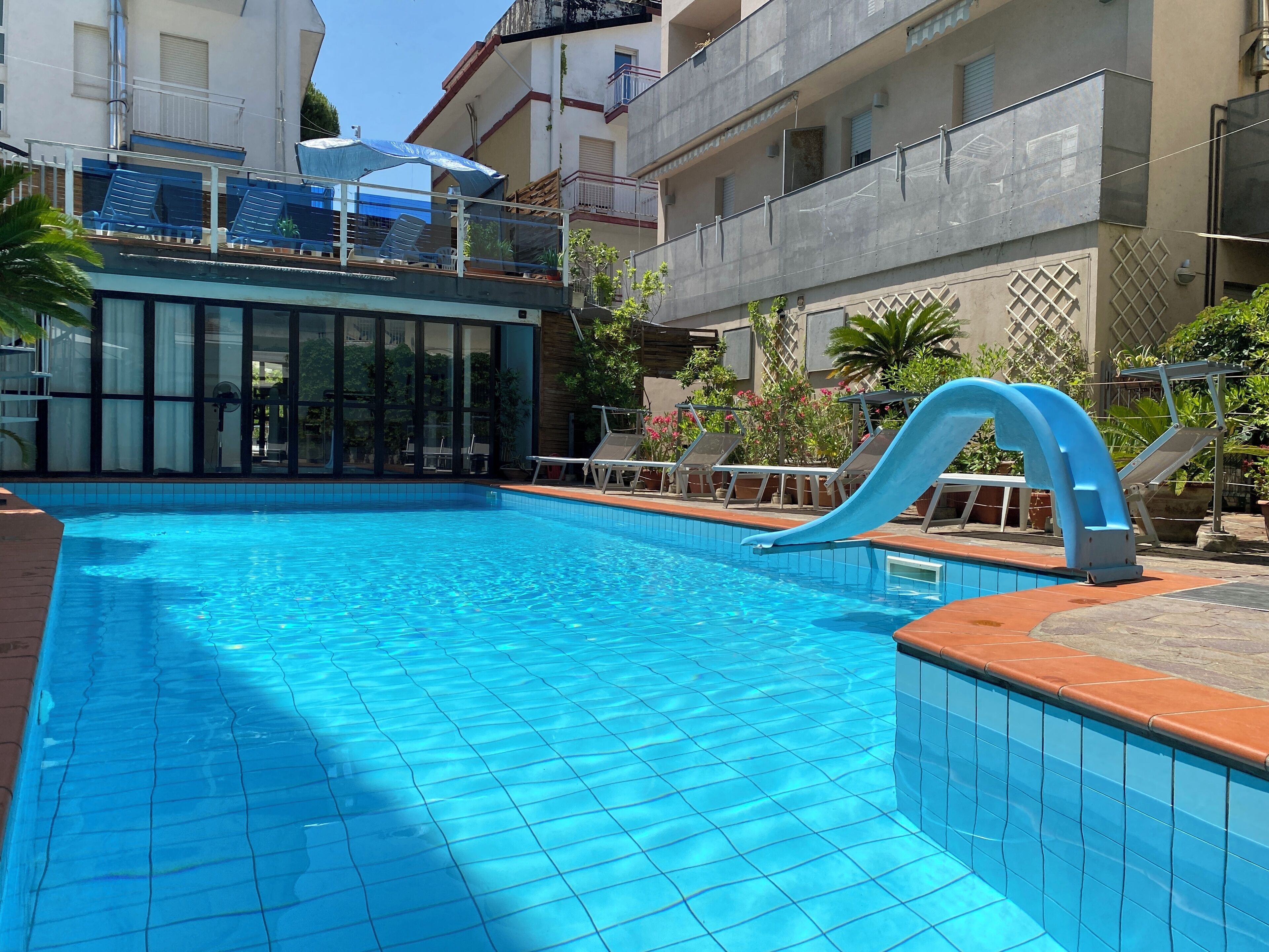 Seasonal outdoor pool, open 9:00 AM to 7:00 PM, pool loungers