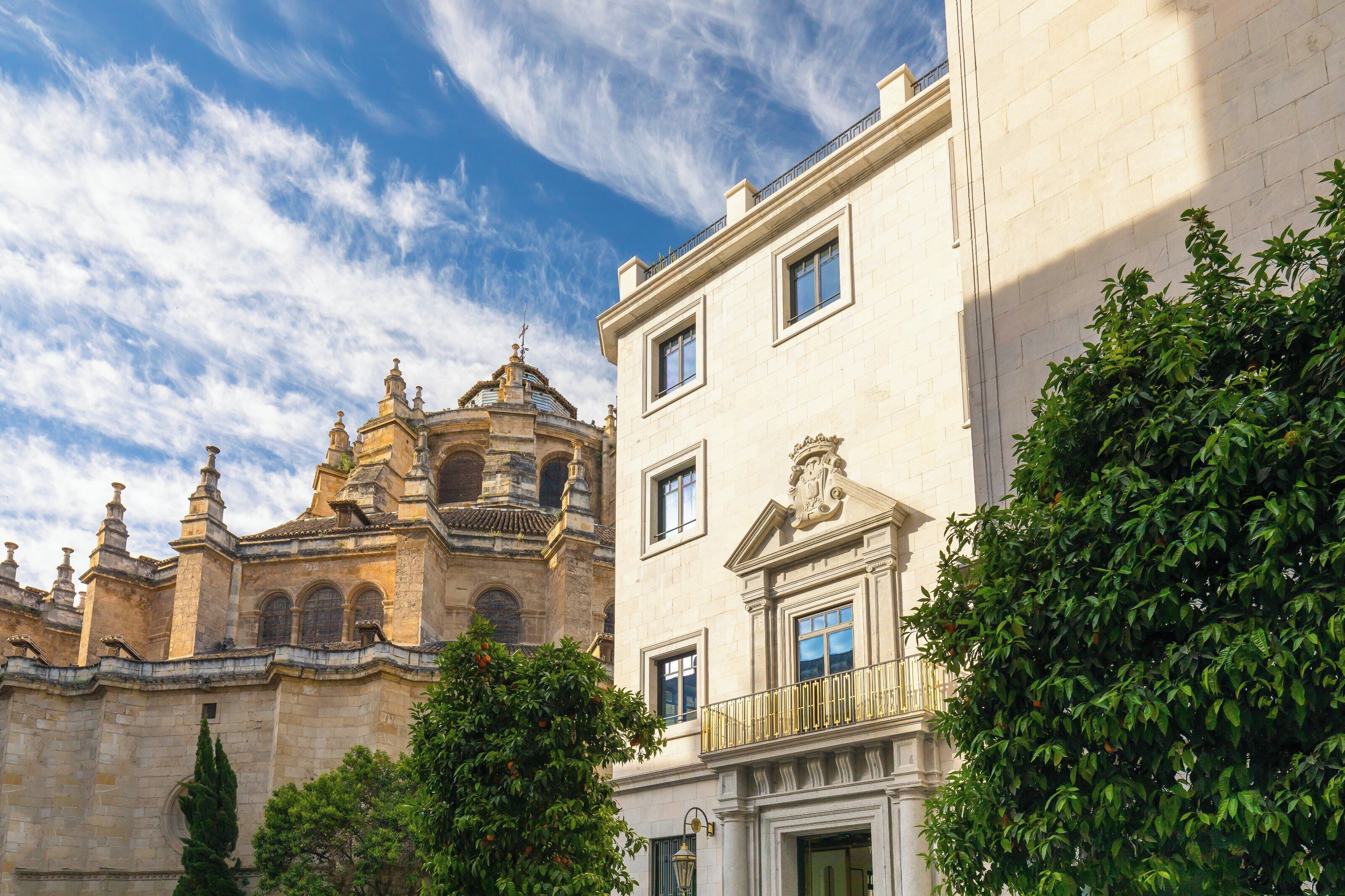 A historic building with classical architecture, including a bell tower and ornate balconies.