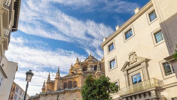 A historic building with ornate architecture, a prominent dome, and a well-maintained facade.