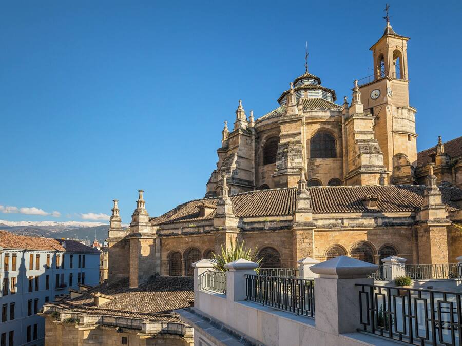 A historic building with a prominent bell tower and arched windows.