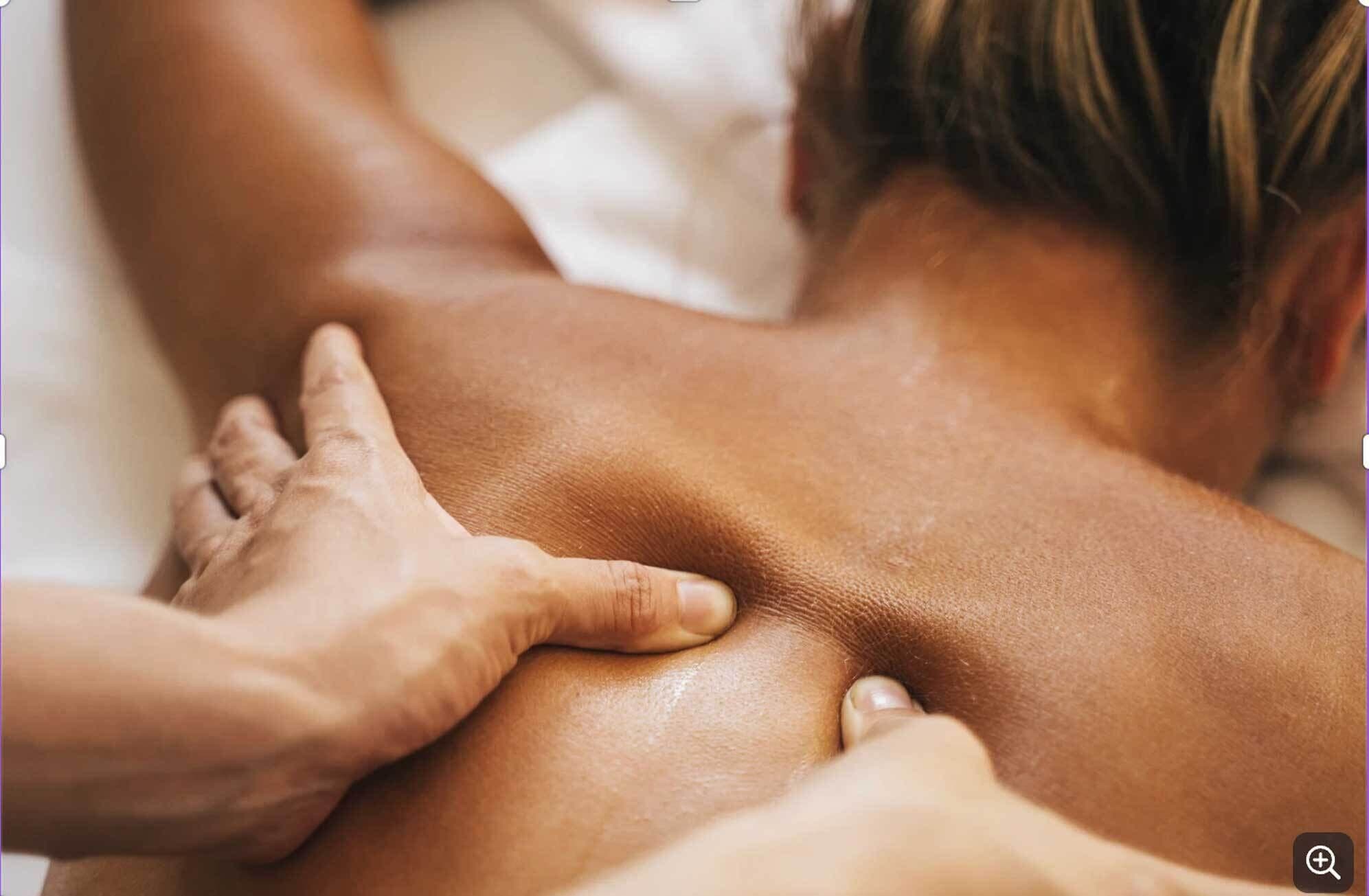 A close-up of a massage being performed on a person's back.