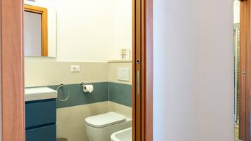 A bathroom with a toilet, sink, and bathtub.