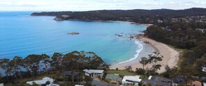 An aerial view of a coastal residential area with houses, a beach, and a clear view of the ocean. - 3-bed With Beach Views and Entertainment Area (Denhams Beach)