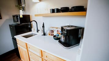Fridge, microwave, coffee/tea maker, cookware/dishes/utensils