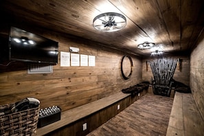 A wooden interior with a television, a sign indicating WiFi availability, and a wall-mounted mirror.