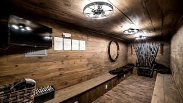 A wooden interior with a television, a sign indicating WiFi availability, and a wall-mounted mirror.