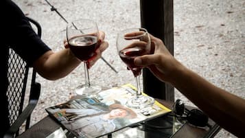 Two people toasting with wine glasses at a table with a magazine.
