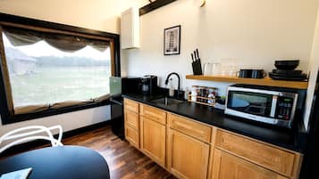 Fridge, microwave, coffee/tea maker, cookware/dishes/utensils