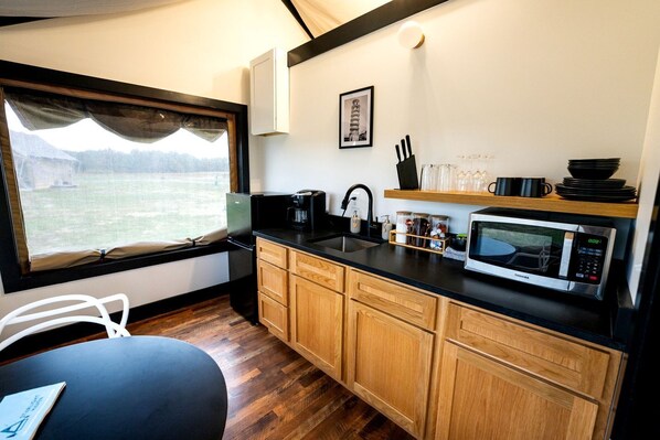 Fridge, microwave, coffee/tea maker, cookware/dishes/utensils