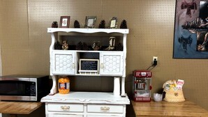 A white vintage-style kitchen with a microwave, a jar of cheese crackers, and a red coffee machine. - Pet-Friendly Safari Tent Glamping in Swan Valley, Idaho near Jackson Hole (Irwin)