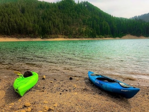 A calm lake with kayaks on the shore. - Pet-Friendly Safari Tent Glamping in Swan Valley, Idaho near Jackson Hole (Irwin)