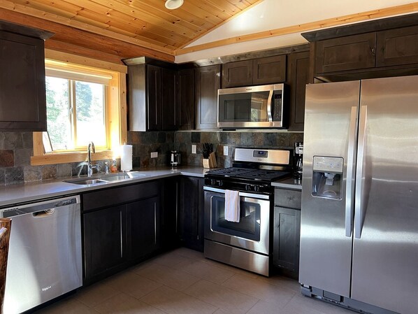 Fridge, stovetop, dishwasher, coffee/tea maker - Cozy 1-Bedroom Log Cabin with Full Kitchen & Wi-Fi | Bonners Ferry, Idaho Retreat (Bonners Ferry)